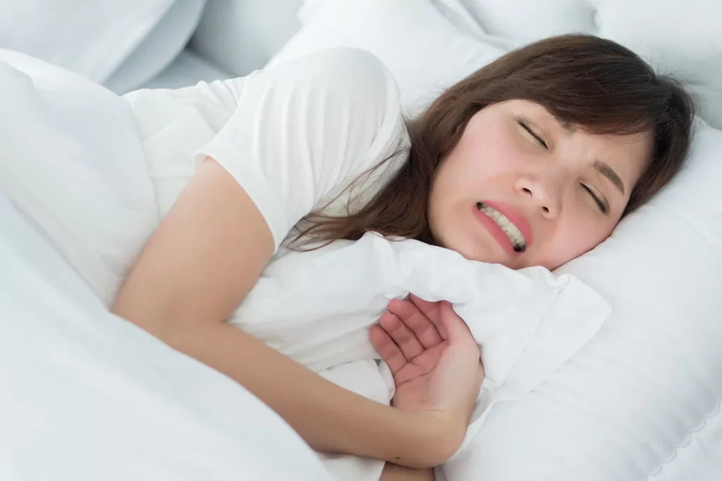 woman with mouth pain from teeth grinding